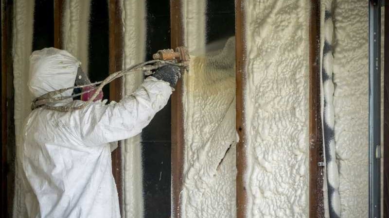 installer applying spray foam insulation