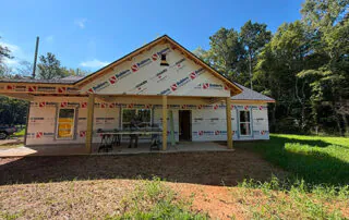 Exterior of a new construction America's Home Place home wrapped in Builders FirstSource HomeGUARD house wrap in Adairsville, GA.