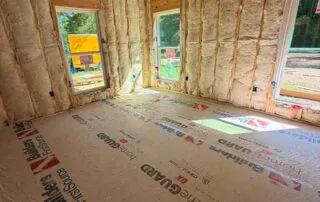 Johns Manville R19 wall batt insulation installed in a framed room with multiple windows in a new construction America's Home Place home in Adairsville, GA.