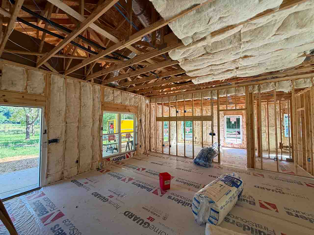 Johns Manville R38 ceiling and R19 wall batt insulation installed in an open-concept framed room in a new construction America's Home Place home in Adairsville, GA.