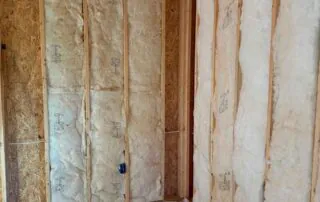 Johns Manville R19 wall batt insulation installed along adjoining walls in a new construction America's Home Place home in Adairsville, GA.