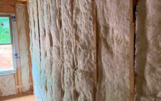 Fiberglass batt wall insulation with R-13 rated packaging installed in a framed DRB Homes new construction home in Stockbridge, GA by Foster Insulation.