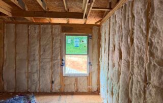 Wide view of fiberglass batt wall insulation installed in a framed DRB Homes new construction home in Stockbridge, GA by Foster Insulation.