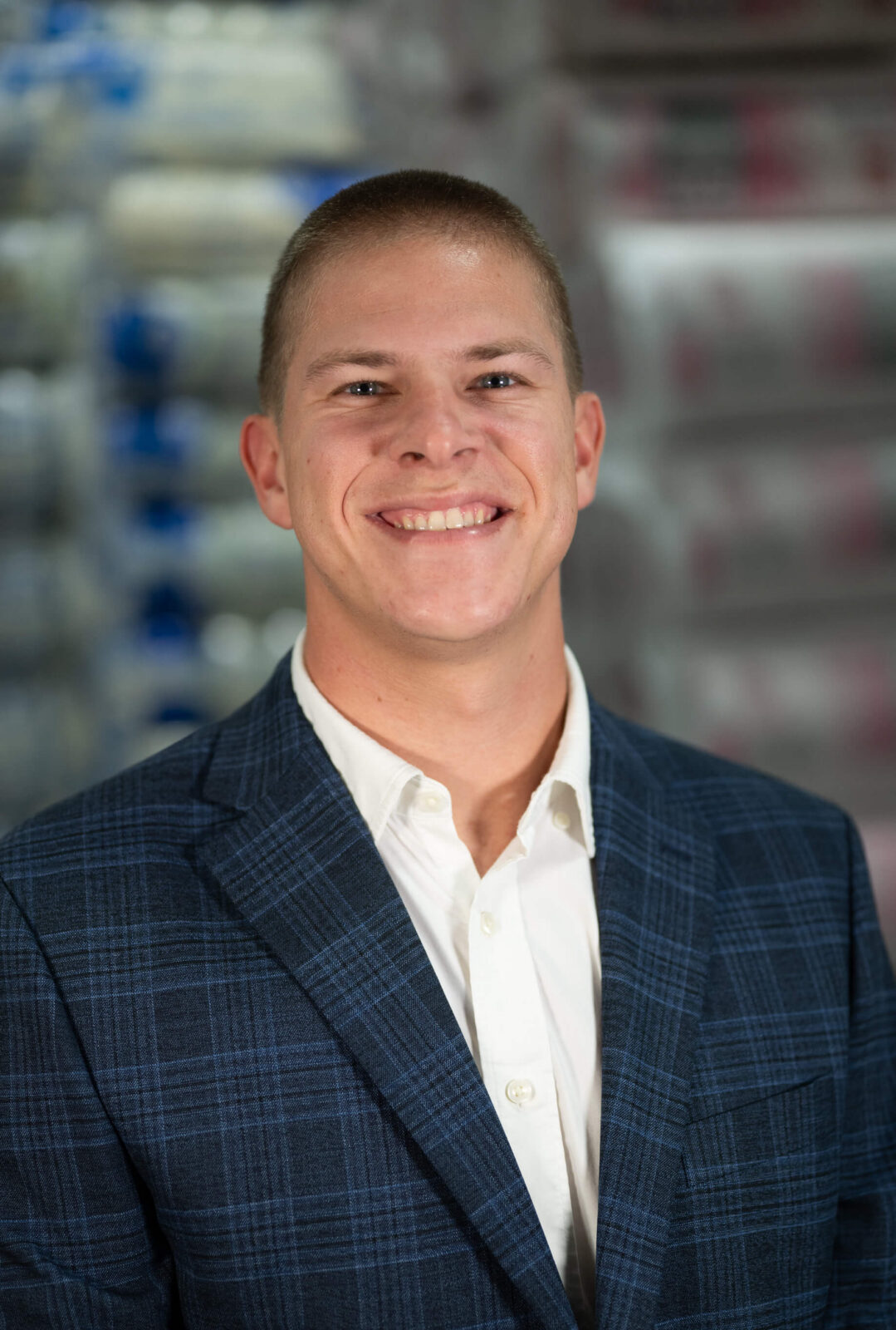 Cayden Klewein Cayden Klewein smiling in a blue plaid suit jacket and white shirt, with a blurred background