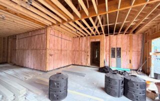 Fiberglass batt insulation installed in the framed walls of a large room in a custom home.