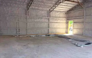 Foster Insulation spray foam insulation applied to the walls and roof of a steel-frame metal building.