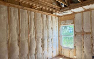 Close view of Foster Insulation unfaced fiberglass batts fitted around a window in a custom home in Cobb County, GA.