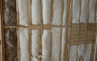 Fiberglass batt insulation installed in bathroom wall of a residential remodel.