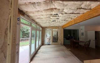 Fiberglass batt insulation installed in the ceiling and walls during a residential remodel.