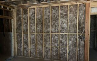 Fiberglass batt insulation installed in a wall of a residential remodel.