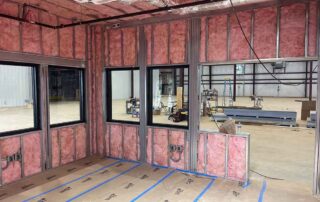 Fiberglass batt insulation installed in walls and ceiling in room of a residential remodel.