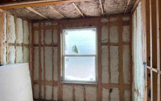 Fiberglass batt insulation installed in the walls and ceiling of a residential remodel.