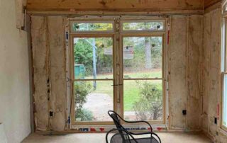 Foster Insulation fiberglass batt insulation installed in the walls and vaulted ceiling around a set of French doors during a residential remodel.