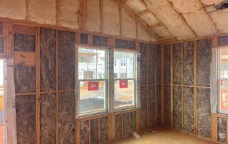 Foster Insulation fiberglass batt insulation installed in the walls and vaulted ceiling of a home under construction.