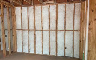 Fiberglass batt insulation installed in walls in a residential remodel.